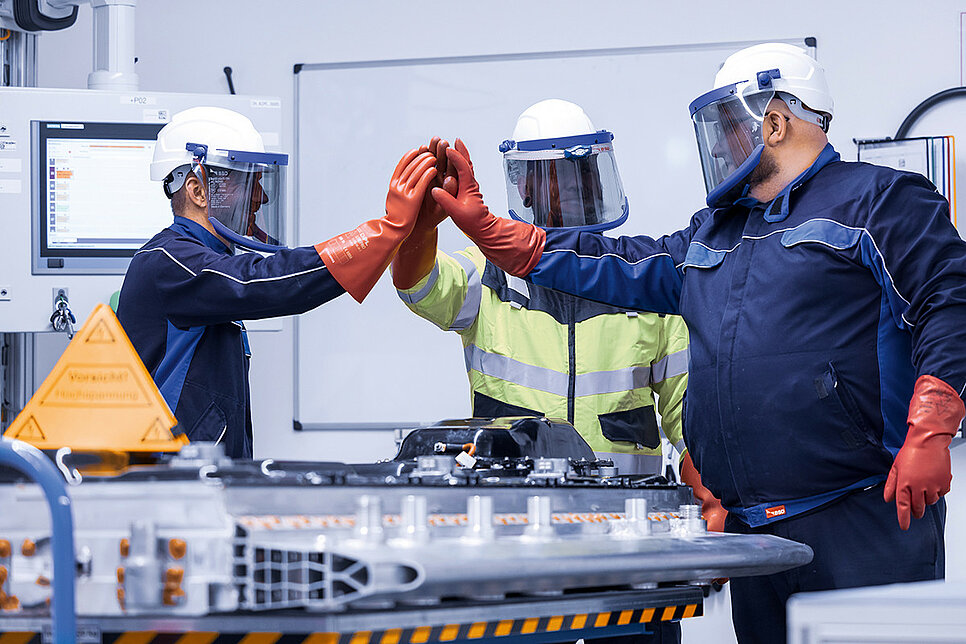 Three Leadec employees in PSA with an EV battery