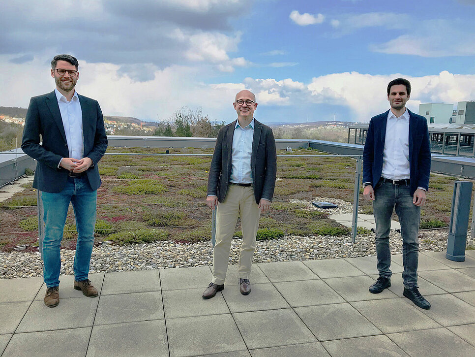 Dr. Bernd Voelpel and Stephan Hihn from Leadec with Dr. Lukas Biedermann from Sparetech on a roof terrace.